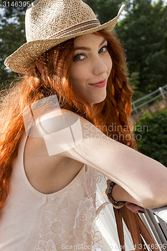 Image of Gorgeous Woman in Hat on Cloudy Sky background