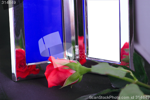 Image of silver frame and red rose