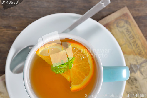 Image of cup of tea and orange slices