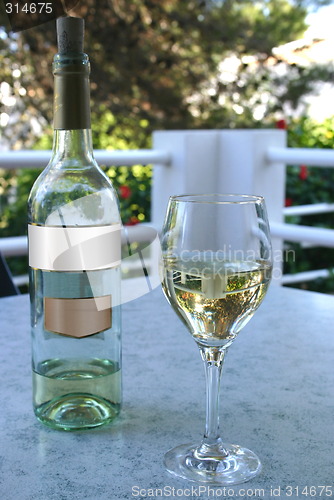Image of glass of wine and bottle