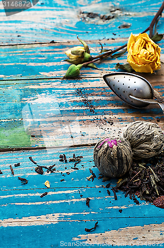 Image of Tea leaves for brewing,tea spoon and dried yellow rose