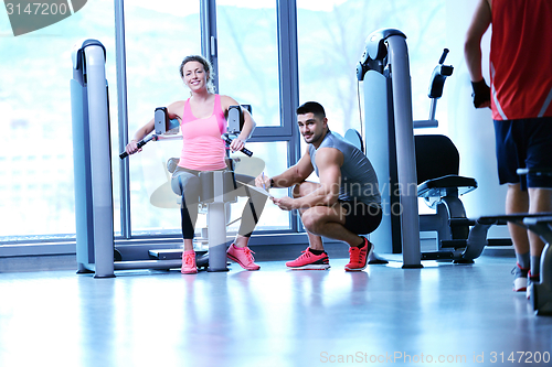 Image of woman exercising with her personal trainer