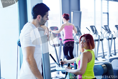 Image of woman exercising with her personal trainer