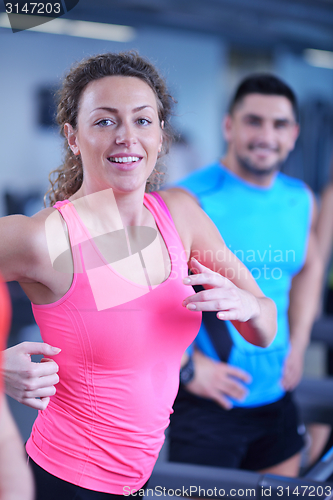 Image of woman exercising on treadmill in gym