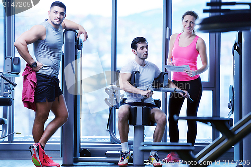 Image of woman exercising with her personal trainer