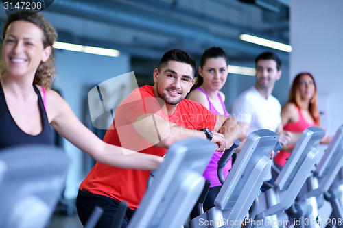 Image of Group of people running on treadmills