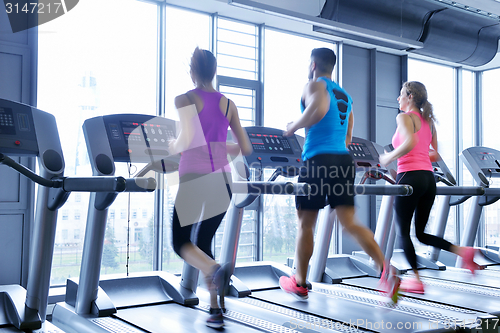 Image of Group of people running on treadmills