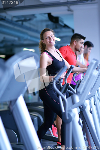 Image of woman exercising on treadmill in gym