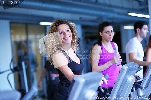 Image of Group of people running on treadmills