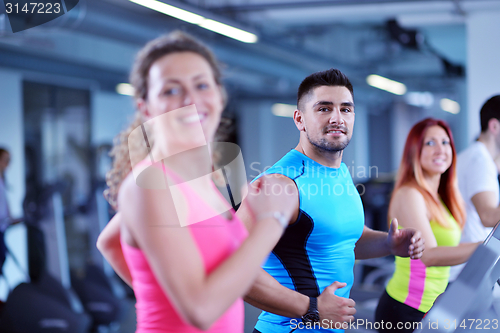 Image of Group of people running on treadmills