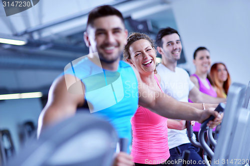 Image of Group of people running on treadmills