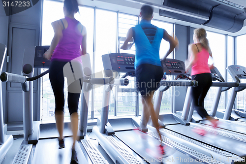 Image of Group of people running on treadmills