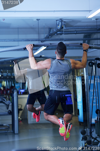 Image of handsome man exercising at the gym