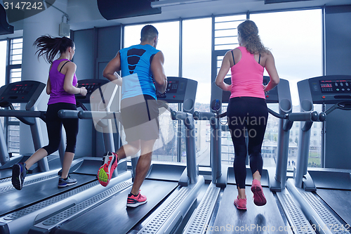 Image of Group of people running on treadmills