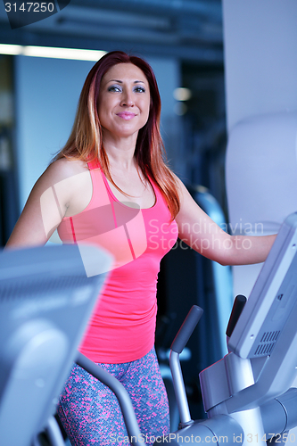 Image of woman exercising on treadmill in gym