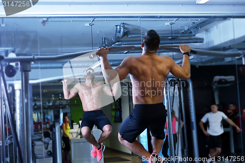 Image of handsome man exercising at the gym