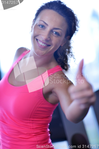 Image of woman exercising on treadmill in gym