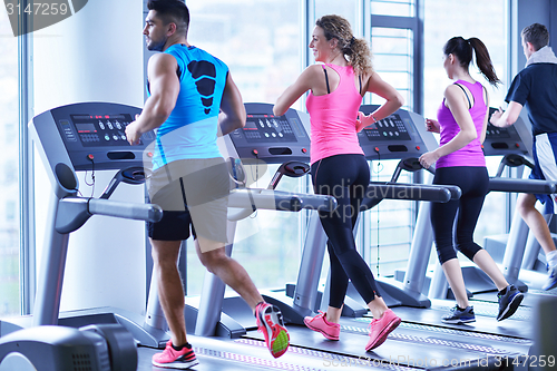 Image of Group of people running on treadmills