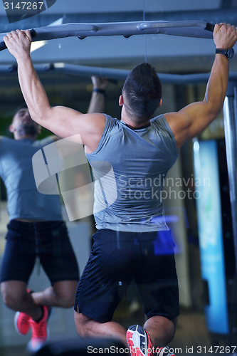 Image of handsome man exercising at the gym