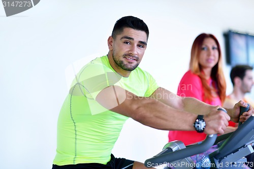 Image of Group of people running on treadmills