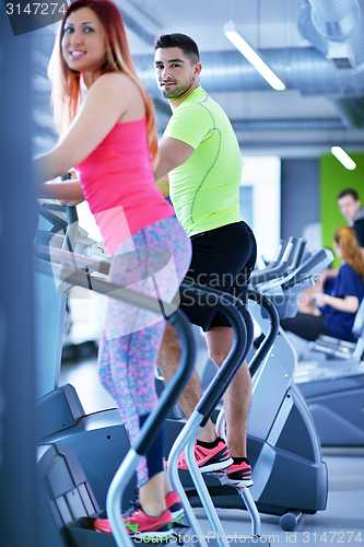 Image of Group of people running on treadmills