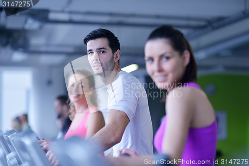 Image of Group of people running on treadmills
