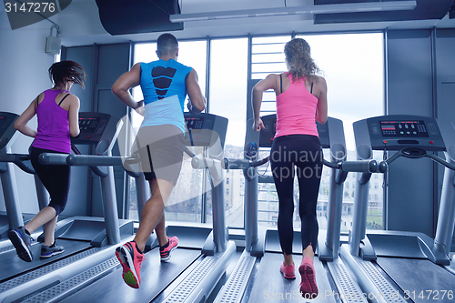 Image of woman exercising on treadmill in gym