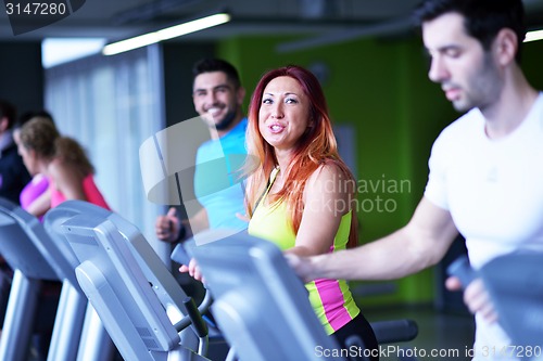 Image of Group of people running on treadmills