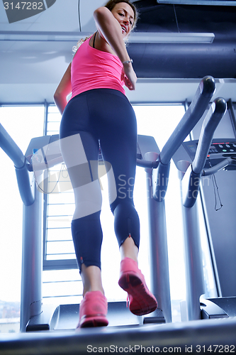 Image of woman exercising on treadmill in gym