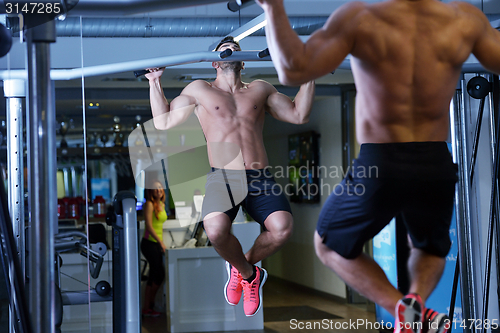 Image of handsome man exercising at the gym