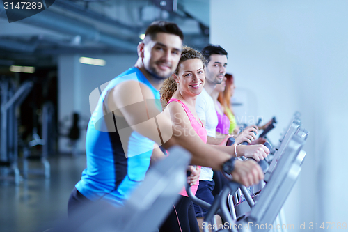 Image of Group of people running on treadmills