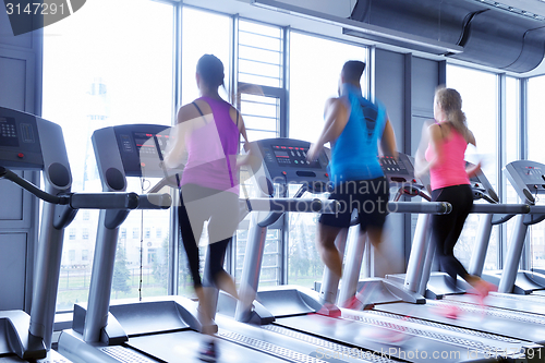 Image of Group of people running on treadmills