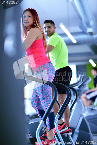 Image of Group of people running on treadmills