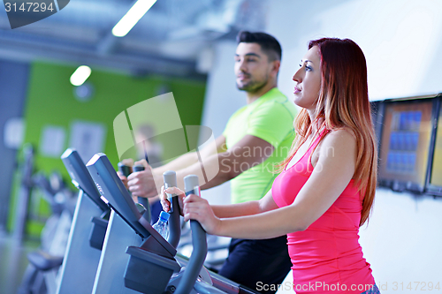 Image of Group of people running on treadmills