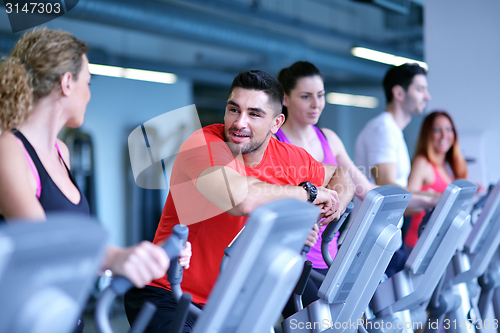 Image of Group of people running on treadmills