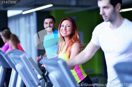 Image of Group of people running on treadmills