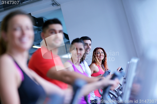 Image of Group of people running on treadmills