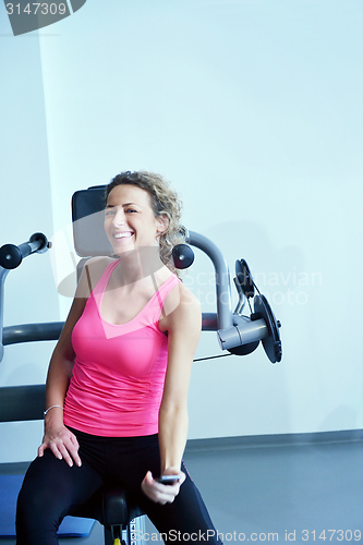 Image of woman stretching and warming up for her training at a gym