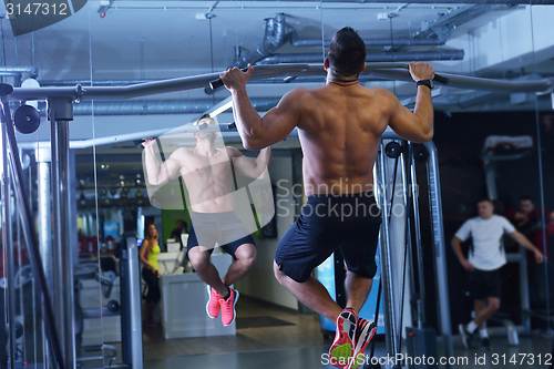 Image of handsome man exercising at the gym