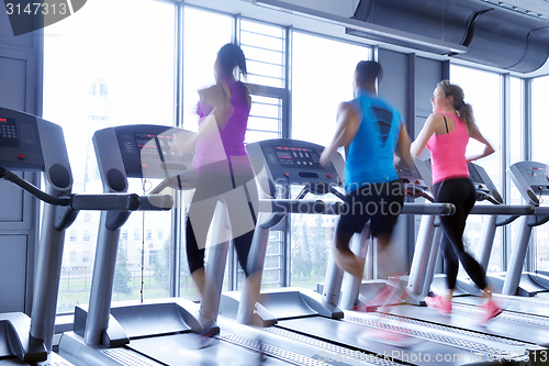 Image of Group of people running on treadmills