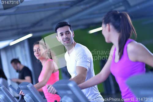 Image of Group of people running on treadmills
