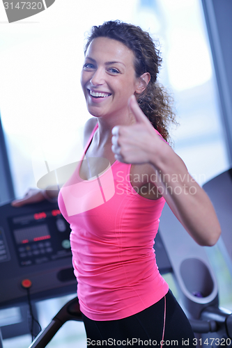 Image of woman exercising on treadmill in gym