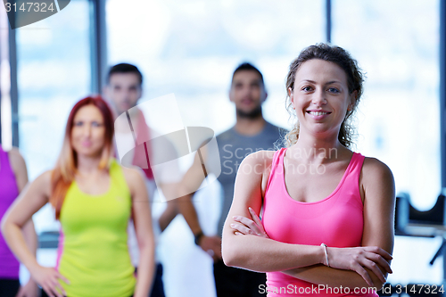 Image of Group of people exercising at the gym