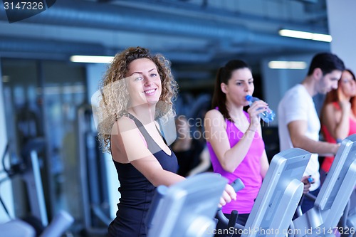 Image of Group of people running on treadmills