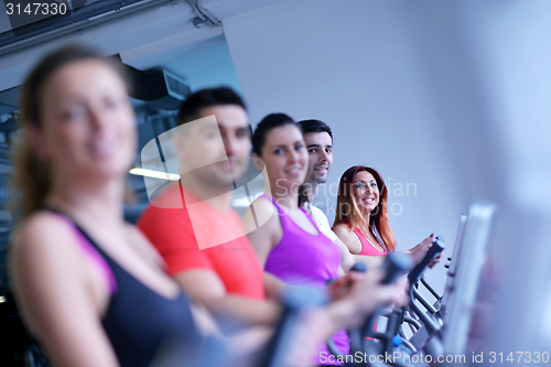 Image of Group of people running on treadmills