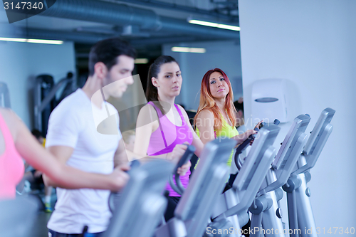 Image of Group of people running on treadmills