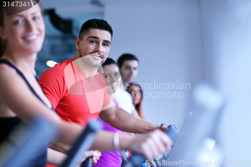 Image of Group of people running on treadmills