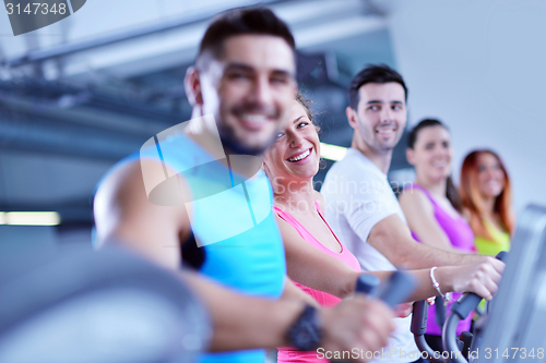 Image of Group of people running on treadmills