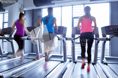 Image of Group of people running on treadmills