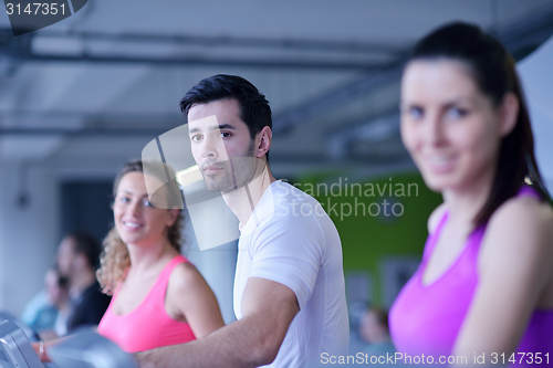 Image of Group of people running on treadmills